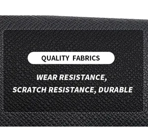 Close up detail of black saffiano leather texture showing wear and scratch resistance features.