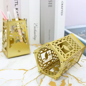 Golden metal hollow pen holder DIY desk organizer, creative stationery stand for office decor.