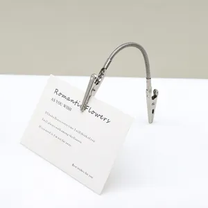 Stainless steel double-ended alligator clip with flexible bendable hose for holding display cards.
