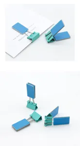 Detailed view of creative blue and turquoise metal binder clips with rectangular plates.