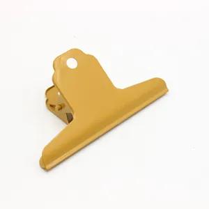 Large yellow metal mountain clip for office paper document organization and art drawing boards.