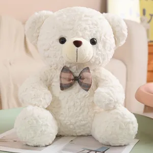 Cute sitting white teddy bear plush toy with plaid bow tie for kids hugging and sleeping soft pillow