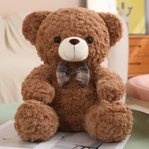 Brown plush teddy bear toy with a cute plaid bow tie, soft sitting posture sleeping pillow.