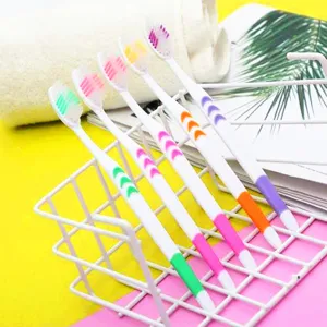 Detailed shot of colorful soft bristle toothbrushes neatly arranged in white wire holder.