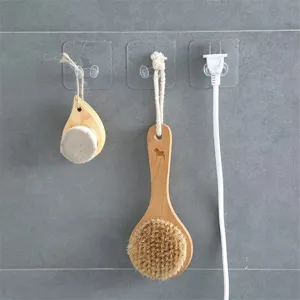 Transparent adhesive wall hook for plugs and cables, heavy-duty nail-free plastic socket hanger.