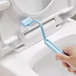 Detail shot showing the curved S-shaped toilet brush cleaning narrow gaps easily.