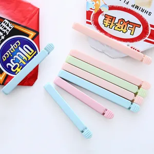 Plastic food sealing clips in pastel colors, fresh snack bag clamps for kitchen storage.