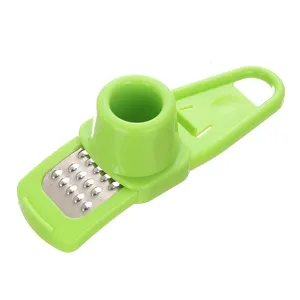 Presse-ail manuel vert et râpe à gingembre, accessoire de cuisine multifonction.