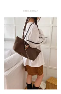 Brown canvas tote shoulder bag with horse charm, large capacity for daily commute and school.