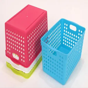 Detailed view of the plastic desktop storage basket with hollow ventilation and convenient handles.