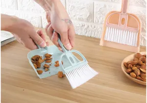 Mini desktop broom and dustpan set cleaning tool for keyboard and small space use.