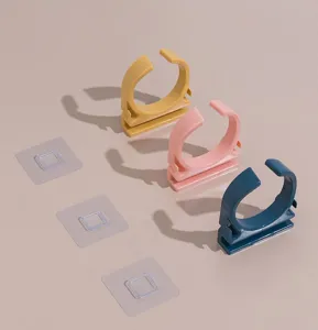 Detailed view of punch-free wall-mounted hair dryer holder clips in multiple colors.