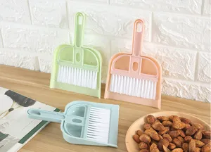 Detail shot of mini desktop broom and dustpan set, portable cleaning brush for keyboard and table.