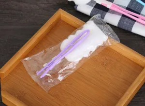 Detail view of the purple folded handle cup cleaning sponge brush in clear packaging.