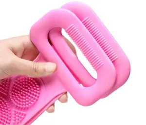 Pink silicone back scrubber bath brush with dual-sided massage bristles for body cleansing.