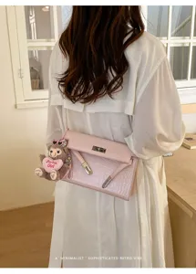 Pink crocodile pattern shoulder crossbody bag with cute teddy bear plush charm detail