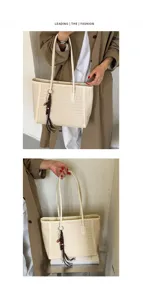 Detailed view of the elegant woven tote bag, showcasing premium texture and spacious interior.