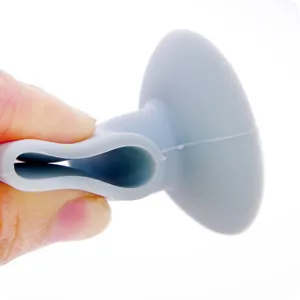 Silicone door stop detail, grey wall protector suction cup showing flexible material texture.