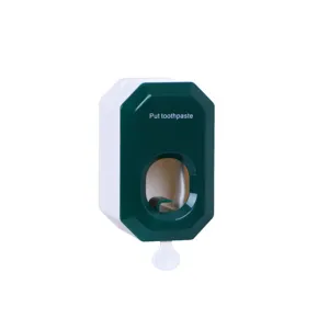 Wall-mounted automatic toothpaste dispenser in green and white, practical bathroom tool.