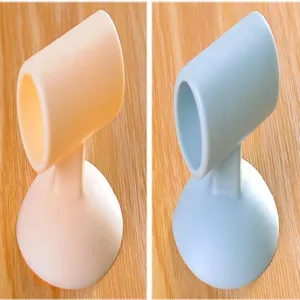 Silicone suction door stop detail shot showing soft bumper pads in pink and light blue colors.