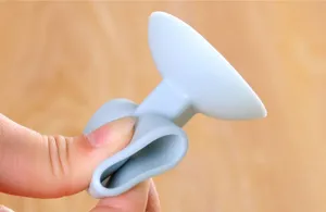 Silicone door stopper detail showing flexible material and suction cup design for home wall protection.
