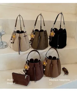 Modische Wildleder Kordelzug Eimertasche mit Blumenanhänger, retro lässige Umhängetasche.