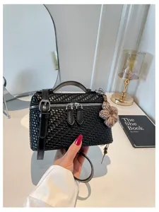 Black woven vanity handbag with top handle and shoulder strap for stylish daily commute use