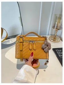 Vintage woven vanity bag detail, Maillard style crossbody shoulder bag with flower charm.
