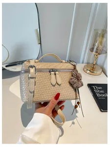 Vintage woven box shoulder bag for women, stylish crossbody handbag with cute flower charm.