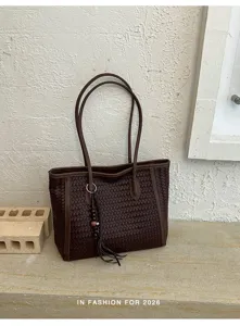 Detail of vintage woven leather tote bag for women, large capacity shoulder bag brown.