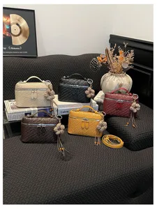 Vintage woven vanity bag for women, stylish top handle shoulder bag with floral charm.