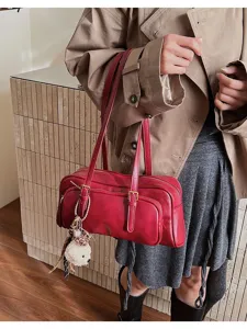 Stylish retro red shoulder underarm bag for women, featuring dual straps and cute bear charm.