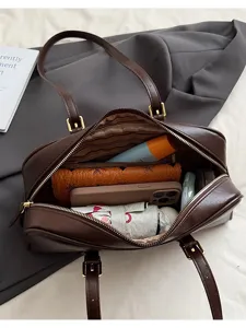 Detailed top view of a dark brown leather handbag interior showcasing large capacity and compartments.