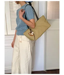 Casual large capacity shoulder tote bag with cute wooden horse charm for daily commute and study.