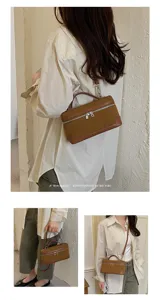 Retro brown suede vanity shoulder bag featuring top handle and adjustable crossbody strap for women.
