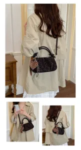 Leopard print cloud shoulder bag detail, stylish retro handbag with plush heart pendant.