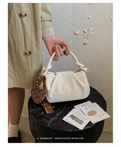 Retro pleated cloud handbag with leopard heart charm and twisted handle for women autumn winter.