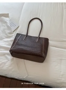 Brown woven leather tote bag detail showing fine craftsmanship and large daily capacity.