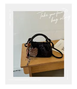 Retro leopard print ruched cloud handbag detail showing soft plush heart charm and elegant strap.