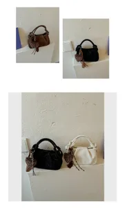 Vintage ruched cloud handbag detail showing unique knotted handles and cute leopard heart charm.