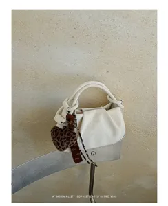 Ruched cloud handbag with leopard heart charm, elegant retro style for daily chic commuting.