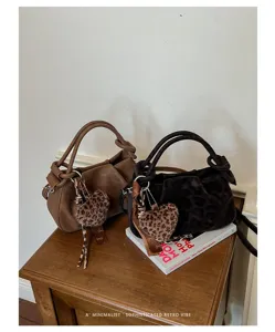Retro pleated cloud handbag with chic leopard heart pendant for women fashion commute.