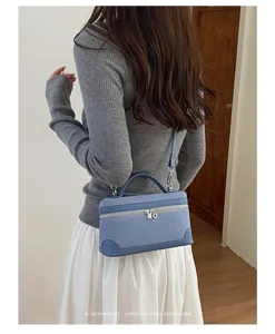 Detailed view of casual retro blue suede vanity shoulder bag in stylish daily life scene.