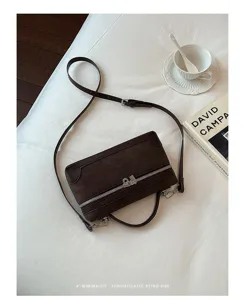 Retro brown suede crossbody lunch box bag with top handle and shoulder strap for women.