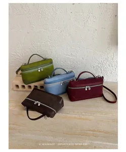 Detail view of retro suede vanity shoulder bags showing fine texture and dual metal zipper design.