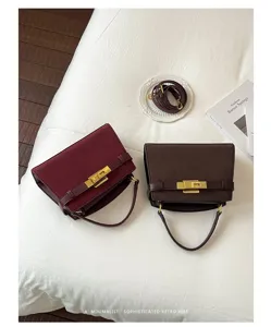 Detailed view of vintage frosted top handle crossbody bags with metal lock and shoulder strap.