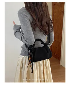 Detail view of black pleated crossbody bag with chic charm, elegant retro vibe style daily use.