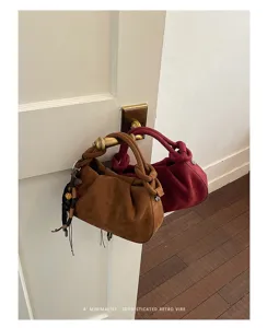 Gros plan sur des sacs à main plissés en suédine tendance avec une texture élégante.