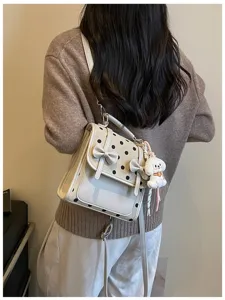 Sweet polka dot backpack with cute puppy pendant, stylish casual daily commuter bag for women.