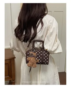 Brown polka dot boston bag featuring cute teddy bear charm, retro shoulder crossbody bag.
